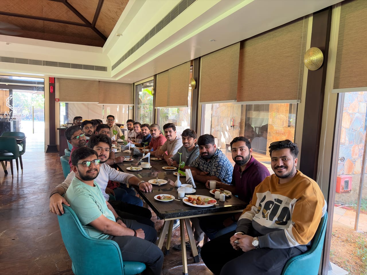 The Insurnest team sharing a long lunch table at a restaurant
