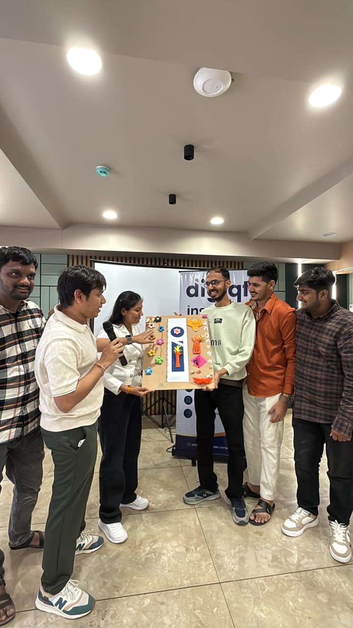 Colleagues gathered around a wrapped gift hamper at the office